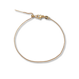 A delicate Kinsey Charm Bar necklace with a gold-filled box chain, featuring an adjustable lobster clasp, arranged in a circular shape on a white background.