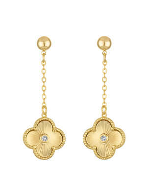 The Vivienne Quatrefoil Drop Earring by Kinsey Designs features gold clover-shaped pendants with central gemstones, linked by a delicate chain for an elegant drop style.