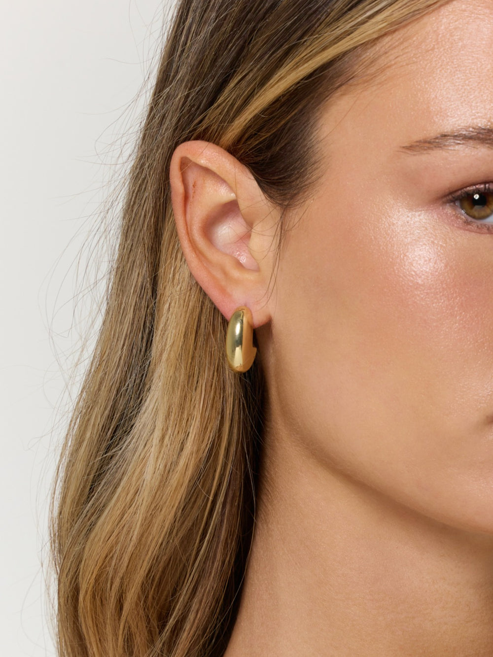 A close-up of a woman's ear adorned with the Weston Earring by Kinsey Designs.