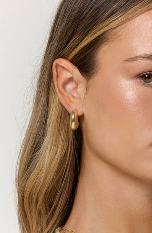 A close-up of a woman's ear adorned with the Weston Earring by Kinsey Designs.