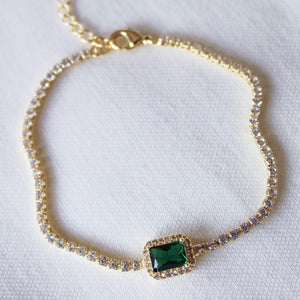 The Kinsey Designs Archives Lara Bracelet – Emerald features a gold filled chain, sparkling cubic zirconia, and a rectangular green gemstone centerpiece. Measures 8 inches for a comfortable fit. Displayed on a white background.