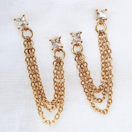 The Becca Double Post earrings by Kinsey Designs Archives feature gold plating, a 2" chain from post to post, square diamond studs, and are displayed on a white background.