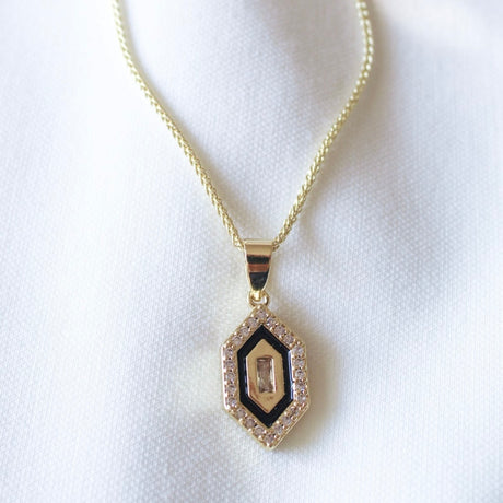 The Harlowe Necklace by Kinsey Designs Archives features a hexagonal cubic zirconia pendant with a central stone and clear crystal border on a 17.75-inch gold filled chain.