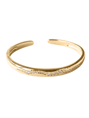The Lily Cuff by Kinsey Designs Archives is a gold-filled bracelet featuring a wavy line of sparkling cubic zirconia, adding elegant sparkle to any outfit.