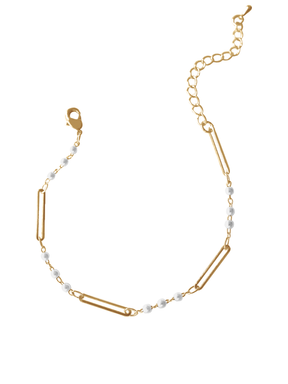 The Marina Pearl Bracelet by Kinsey Designs Archives features elongated gold links, small white pearls, and an adjustable clasp for a perfect fit.