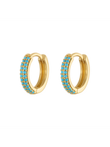The Miles Huggie Earrings by Kinsey Designs feature rows of vibrant turquoise stones set in small gold hoops, shown on a white background.