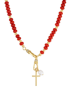 The Katherine Cross Gemstone Necklace by Kinsey Designs features red and gold beads, carnelian accents, a gold cross pendant, and a single white pearl charm.