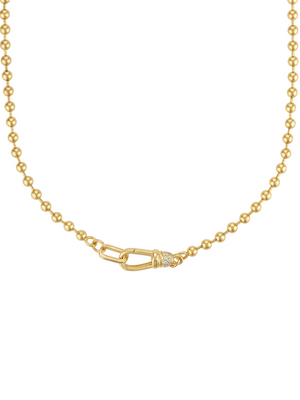 The Juniper Ball Chain Necklace by Kinsey Designs features gold beading, a distinct oval front clasp, and a delicate wrapped center detail.