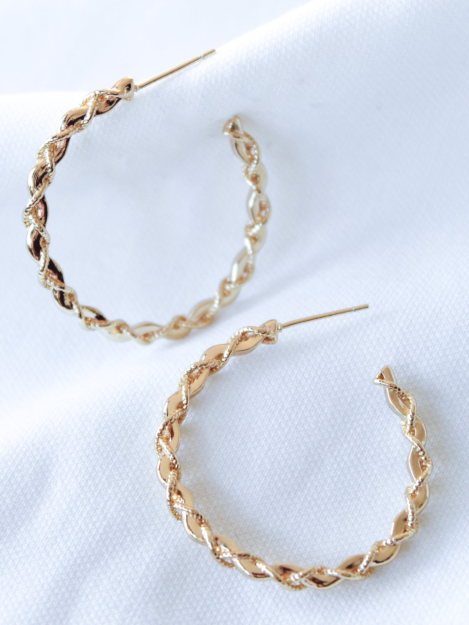 The Cru Hoop by Kinsey Designs Archives features gold filled twisted hoop earrings with a 1.25" diameter, displayed on a white fabric background.