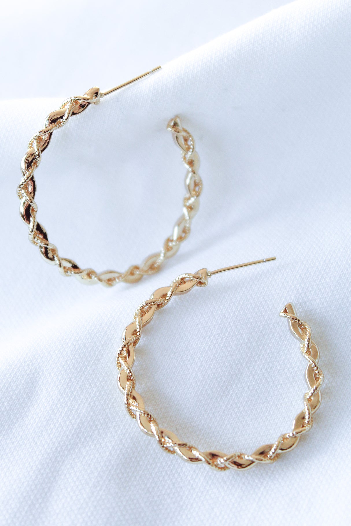 The Cru Hoop by Kinsey Designs Archives features gold filled twisted hoop earrings with a 1.25" diameter, displayed on a white fabric background.