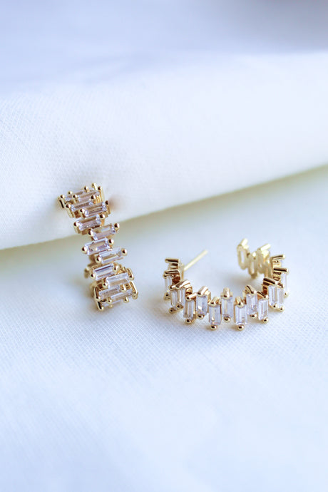 The Ettie Hoop by Kinsey Designs Archives is a pair of gold filled earrings with 1" diameter, featuring rectangular cubic zirconia stones in a row, shown on a white fabric background.