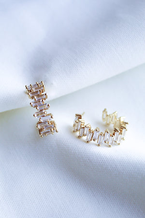 The Ettie Hoop by Kinsey Designs Archives features 1" gold filled earrings with rectangular cubic zirconia stones in a row, shown on white textured fabric.