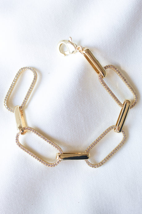 The Jameson Bracelet by Kinsey Designs, featuring rectangular links, is shown on a white fabric background.