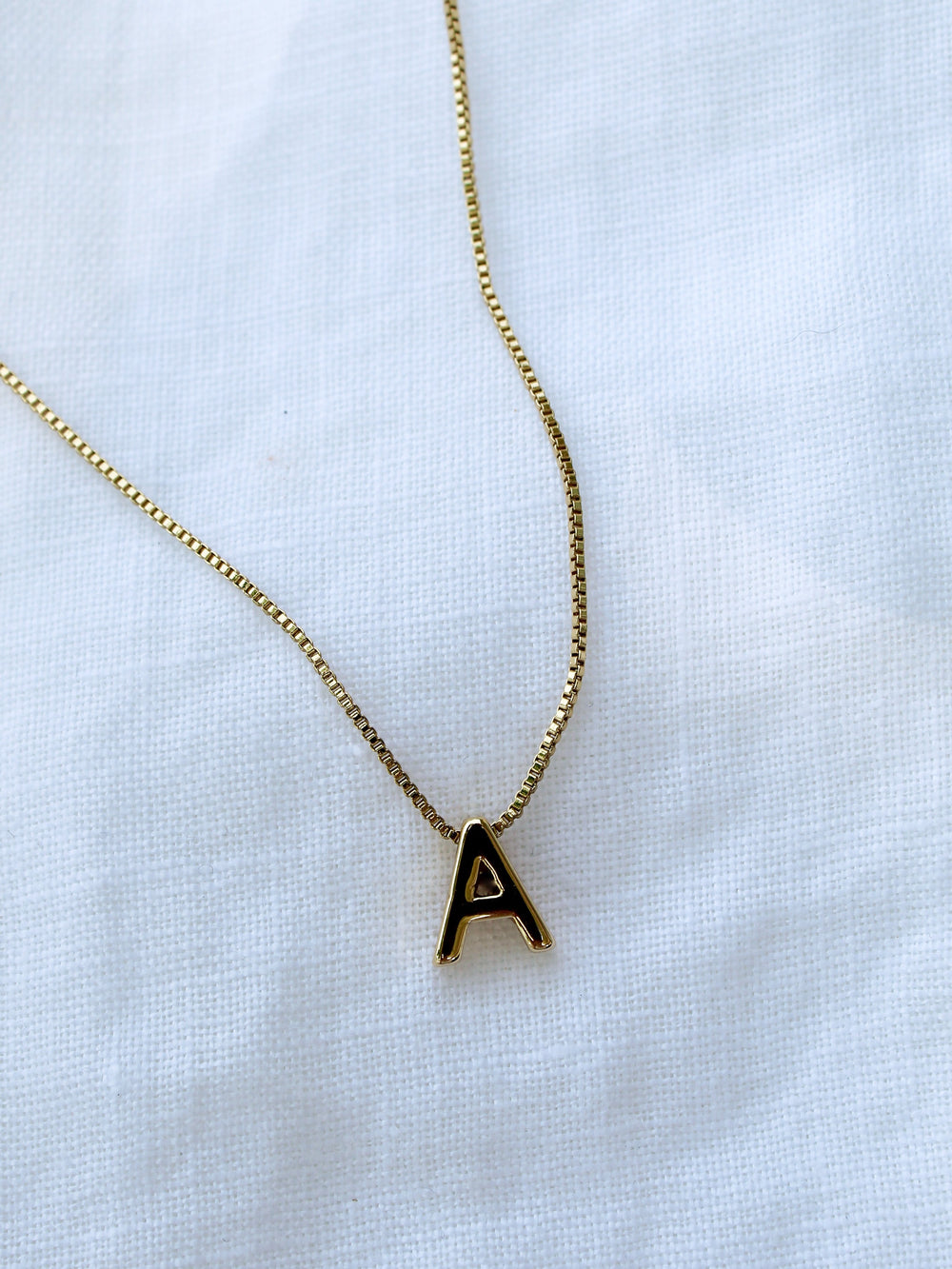 Kinsey Designs Collection Kinsey Slide Initial Necklace Letter A displayed on a white fabric background.