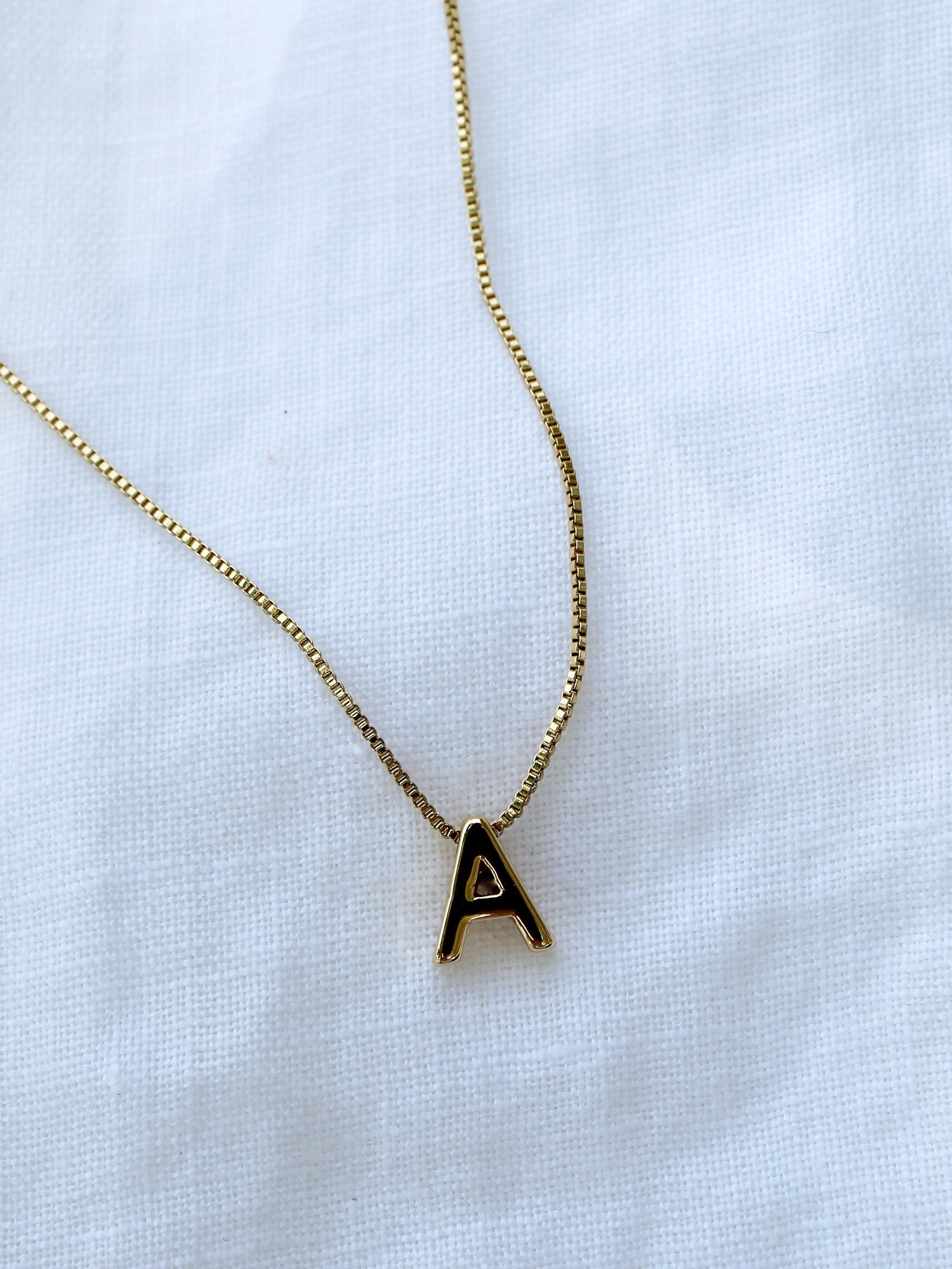 Kinsey Designs Collection Kinsey Slide Initial Necklace Letter A displayed on a white fabric background.
