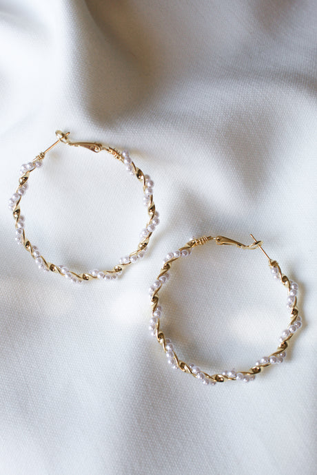 The Mac Hoop by Kinsey Designs Archives features gold filled hoops with a 2" diameter and small white pearls, displayed on a soft white fabric background.
