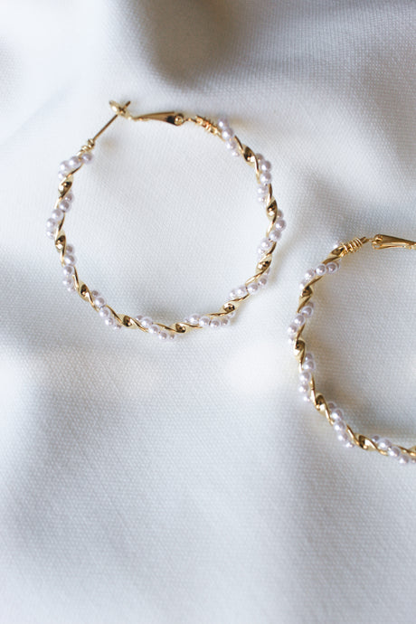 The Mac Hoop by Kinsey Designs Archives features gold-filled hoops with small white pearls, 2" in diameter, shown on a soft white textured fabric background.