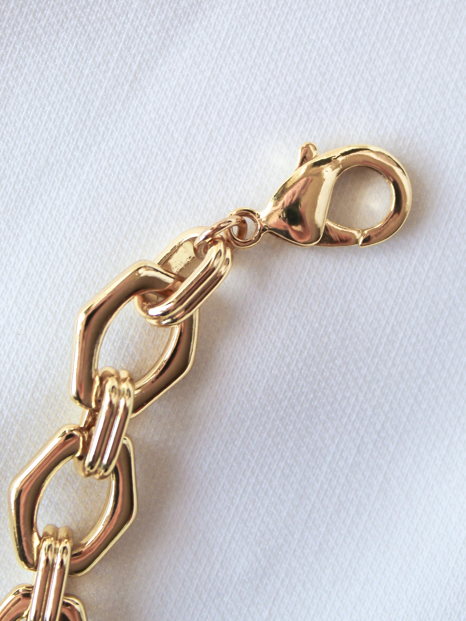 The Prague Necklace by Kinsey Designs Archives features a 14k gold filled chain with a lobster clasp, displayed on white textured fabric.
