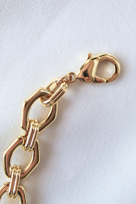 The Prague Necklace by Kinsey Designs Archives features a 14k gold filled chain with a lobster clasp, displayed on white textured fabric.