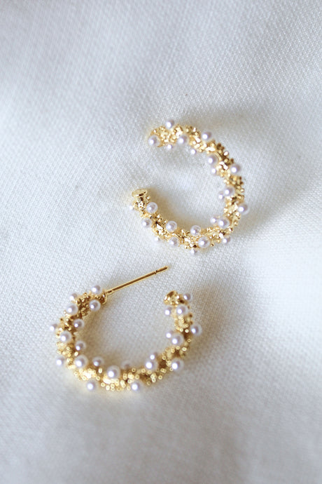 Kinsey Designs Archives' Reef Hoop earrings, 2" gold hoops adorned with small pearls, are displayed on a soft white fabric background; one size fits all.