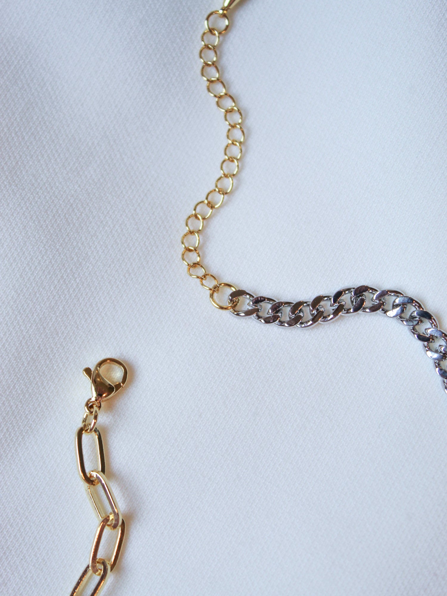 Saxon Mixed necklaces by Kinsey Designs Archives—gold-filled and silver 18" chains with clasps on white fabric—perfect for any sample sale.