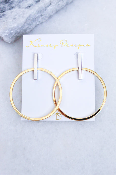Jocelyn - Mixed Metals gold plated hoop earrings with silver bars (2.5”L x 2”W) by Kinsey Designs Archives, shown on a branded white card atop marble.