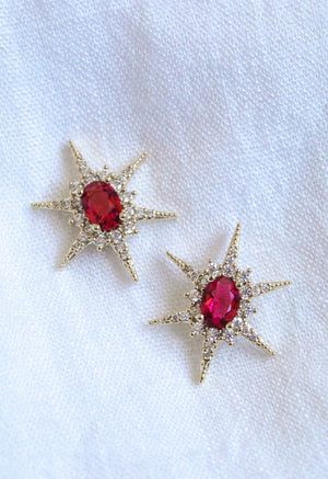 Faye Stud star-shaped earrings by Kinsey Designs feature gold-filled design, red center stones, and cubic zirconia accents. Shown on white fabric—add sparkle to your look! Shop now at our sample sale.