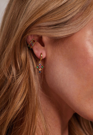 Close-up of a woman's ear wearing Kinsey Designs Archives' Tori Huggie - Multi, a gold filled hoop with colorful stones, and a sparkling cubic zirconia ear cuff.