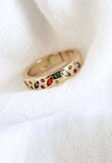 The Luna Ring - Multi by Kinsey Designs Archives features gold plating and multicolored gemstones in size 7, elegantly displayed on white fabric.
