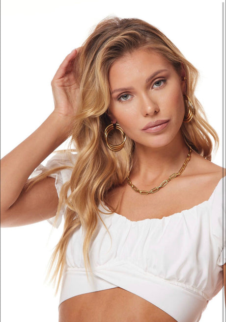 Woman with long blonde hair wears a white top, Kinsey Designs Archives Lexie Triple Hoop gold plated earrings (1.75" wide), and a gold chain necklace.