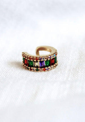 The Clementine Ear Cuff by Kinsey Designs Archives features colorful rectangular cubic zirconia set in gold fill, displayed on a white textured surface.