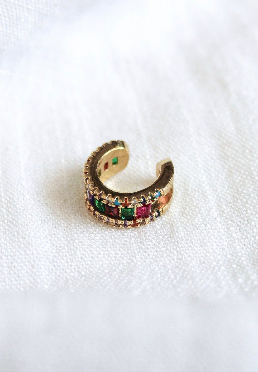 Clementine Ear Cuff by Kinsey Designs Archives—gold filled, adorned with multicolored cubic zirconia gemstones, displayed on a white textured fabric. SAMPLE SALE.