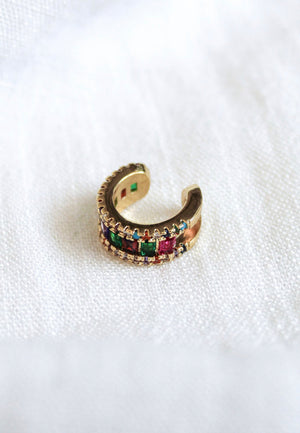 Clementine Ear Cuff by Kinsey Designs Archives—gold filled, adorned with multicolored cubic zirconia gemstones, displayed on a white textured fabric. SAMPLE SALE.