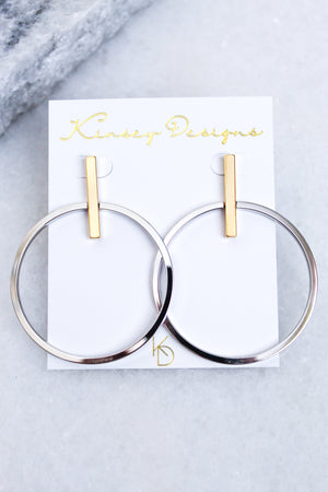 The Jocelyn - Mixed Metals earrings by Kinsey Designs Archives are large silver hoops with gold-plated rectangular posts, measuring 2.5” long by 2” wide, displayed on a white Kinsey Designs card.